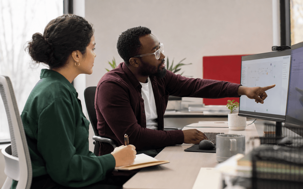 Product researcher interviewing a business software user at work