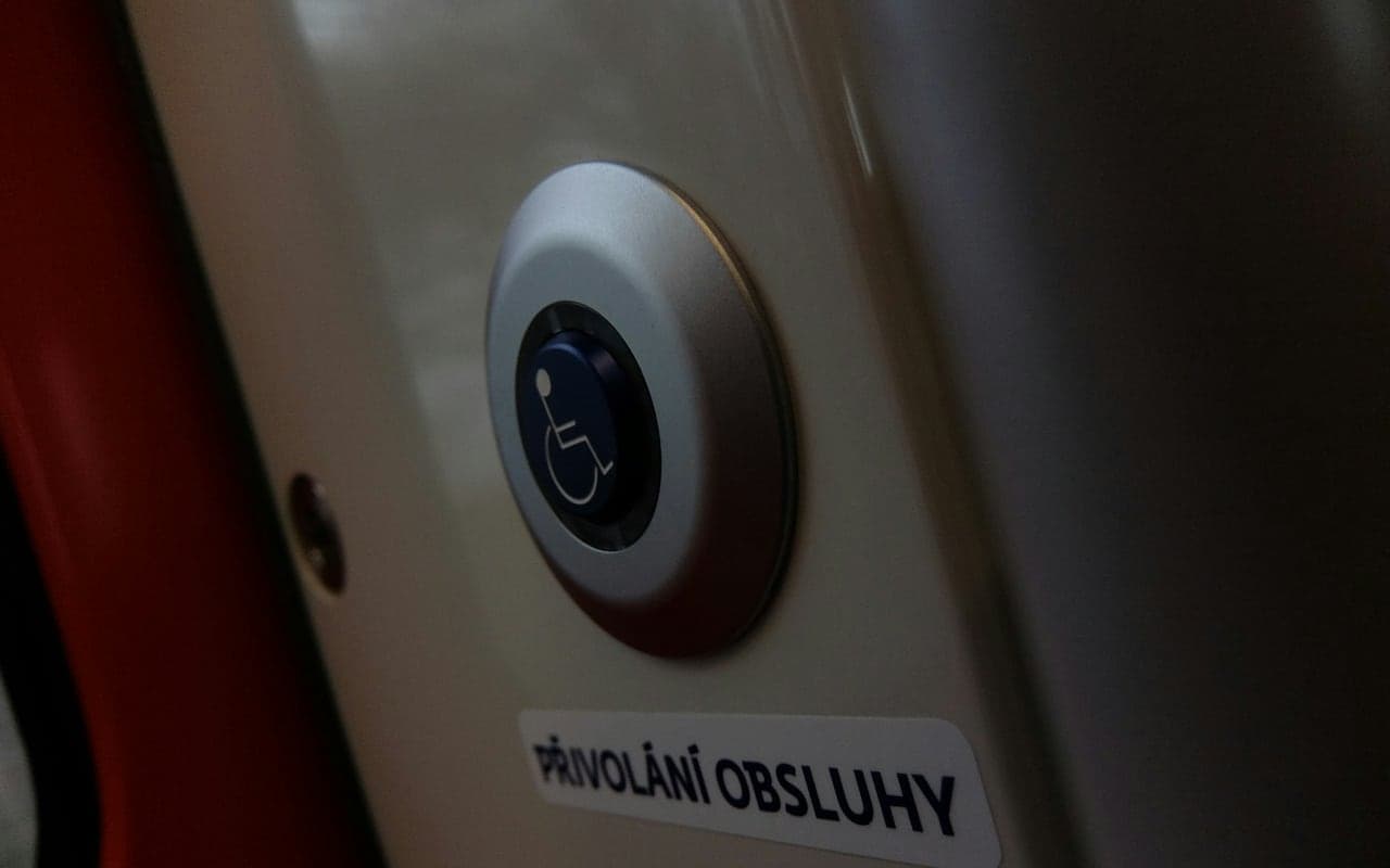 Physical accessibility button demonstrating an inclusive interaction control