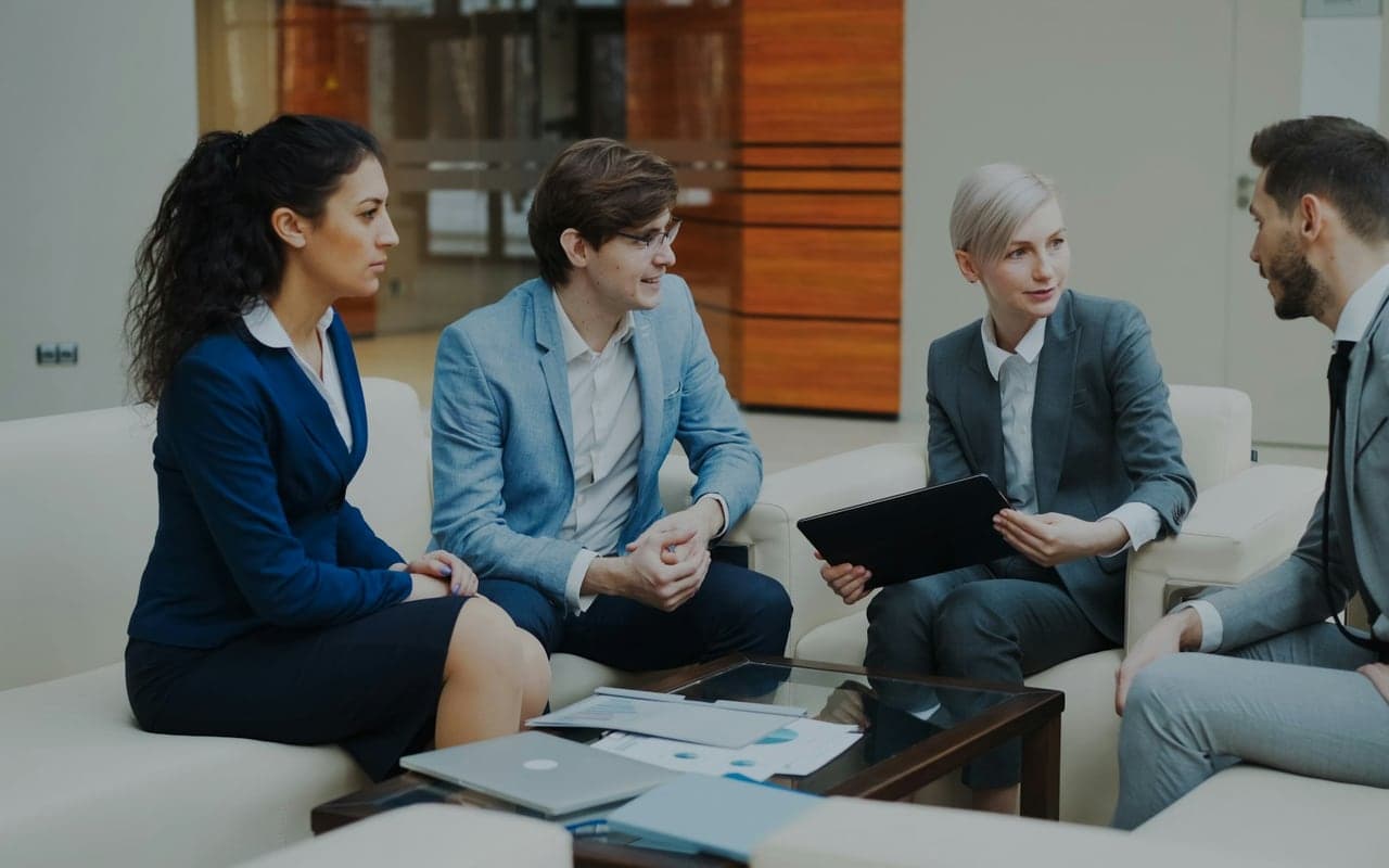 Business team reviewing documents and a tablet during due diligence